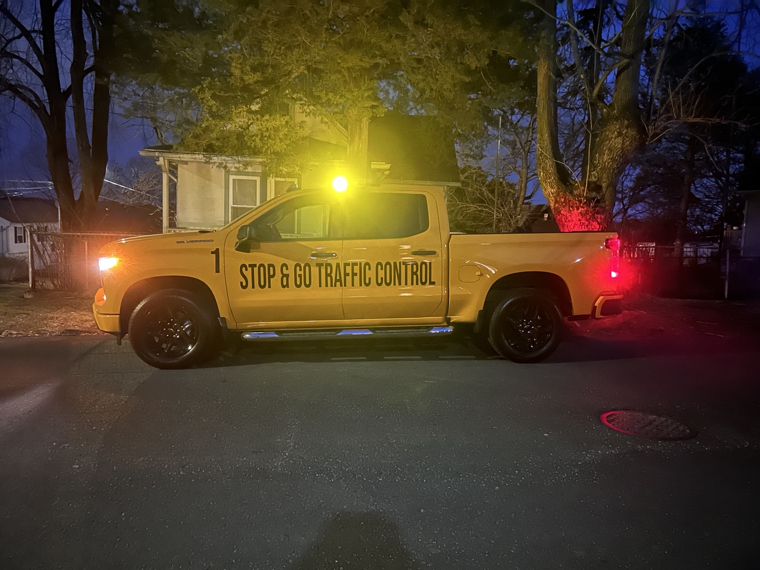 Stop & Go truck at dusk with its amber beacon illuminated.
